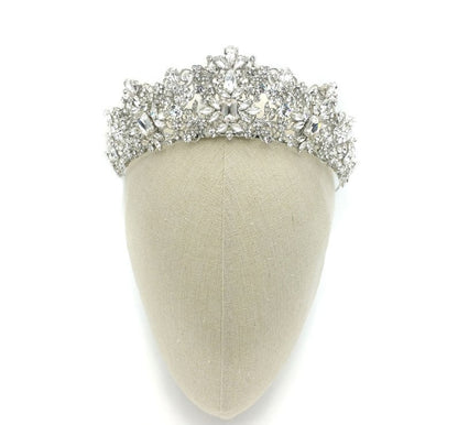 Silver tiara on a mannequin head with a white background